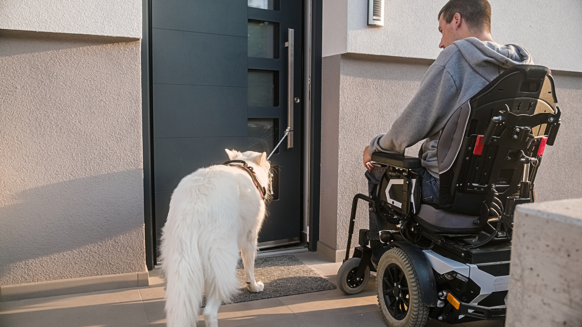 Man in wheelchair entering widened doorway of a home in Long Island, NY