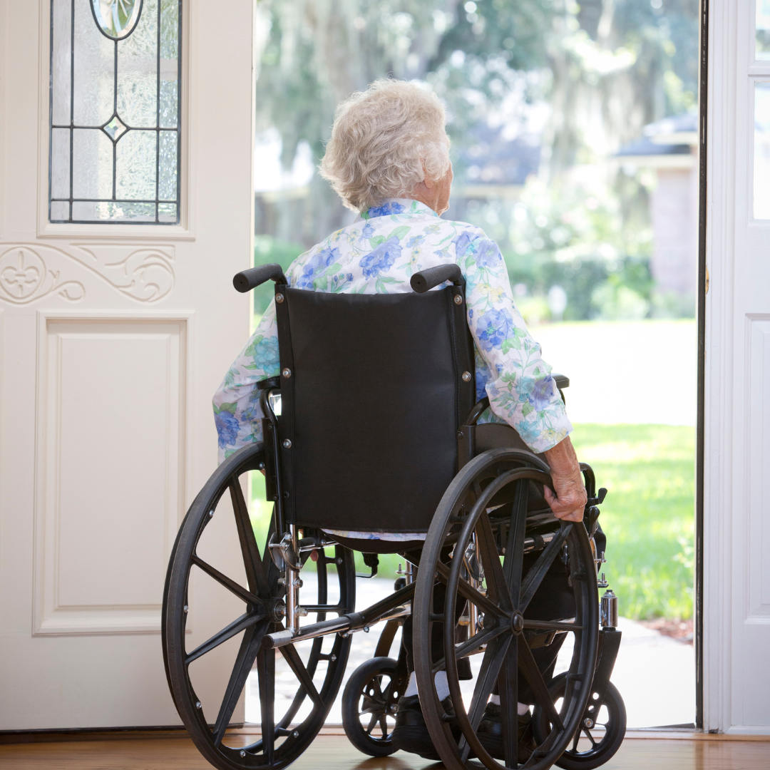 Senior in wheelchair exiting a home with a widened front doorway