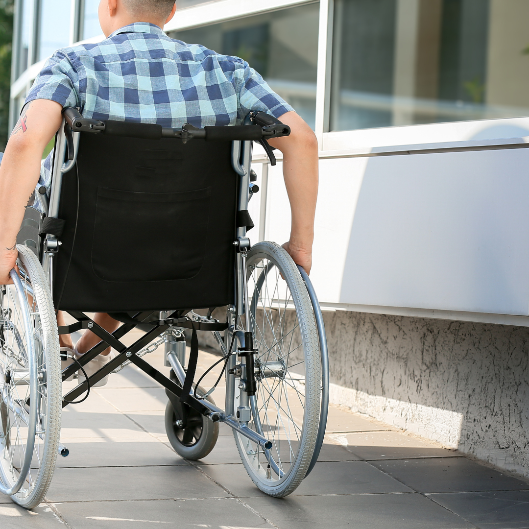 Man in wheelchair using a newly installed wheelchair ramp